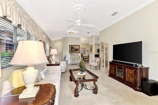 living room with light carpet, ceiling fan, and ornamental molding