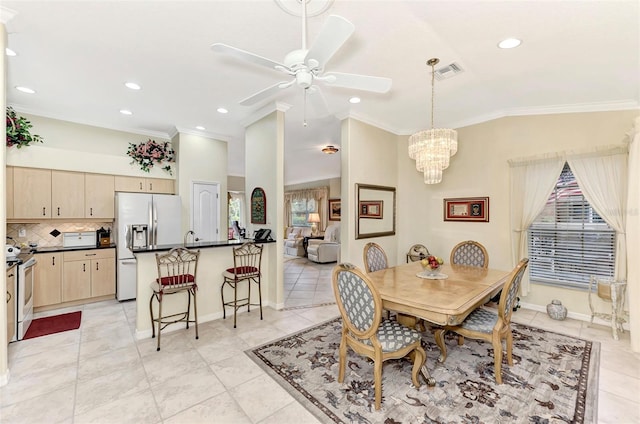 tiled dining space featuring a healthy amount of sunlight, ornamental molding, and ceiling fan with notable chandelier