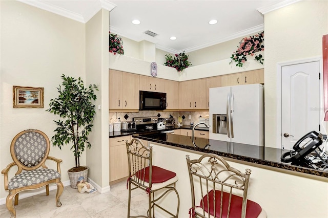 kitchen featuring dark stone countertops, backsplash, light tile flooring, and stainless steel appliances