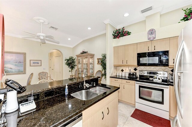 kitchen featuring ceiling fan, tasteful backsplash, white appliances, dark stone countertops, and sink