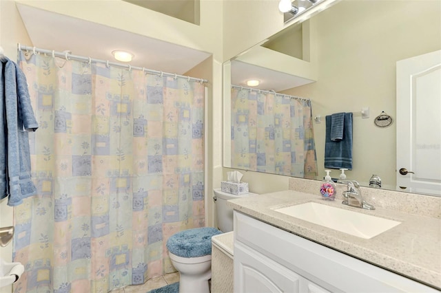 bathroom featuring tile flooring, vanity with extensive cabinet space, and toilet