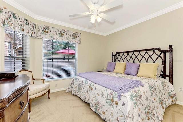 bedroom with light colored carpet, ceiling fan, multiple windows, and crown molding