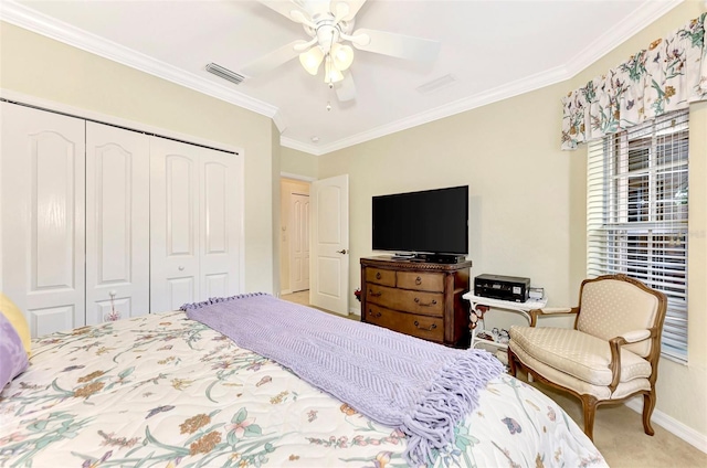 carpeted bedroom with crown molding, a closet, and ceiling fan