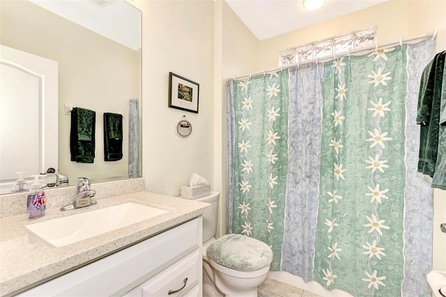 bathroom featuring toilet, large vanity, and tile floors