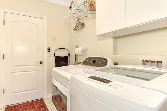 laundry room with cabinets, separate washer and dryer, ornamental molding, and tile flooring