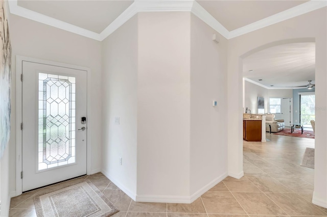 entrance foyer featuring ornamental molding, ceiling fan, and light tile floors