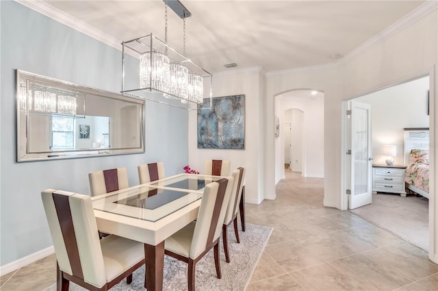 dining room with a notable chandelier, light carpet, and ornamental molding