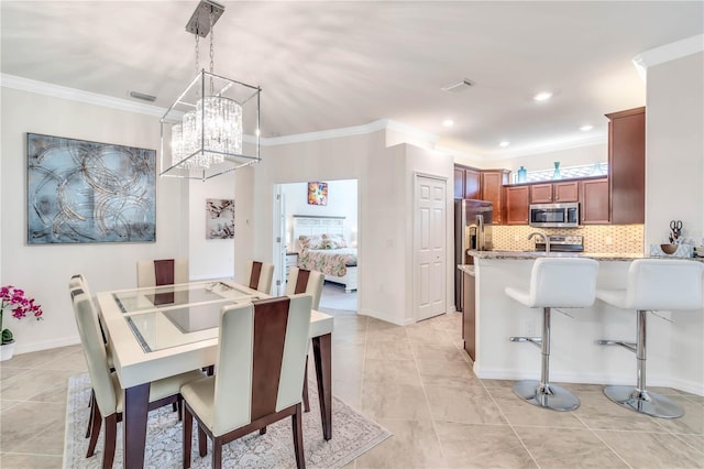 tiled dining area with crown molding and an inviting chandelier