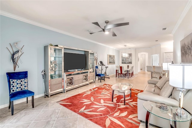 living room featuring light tile flooring, ornamental molding, and ceiling fan with notable chandelier