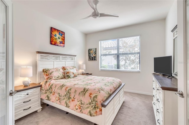 bedroom featuring light carpet and ceiling fan