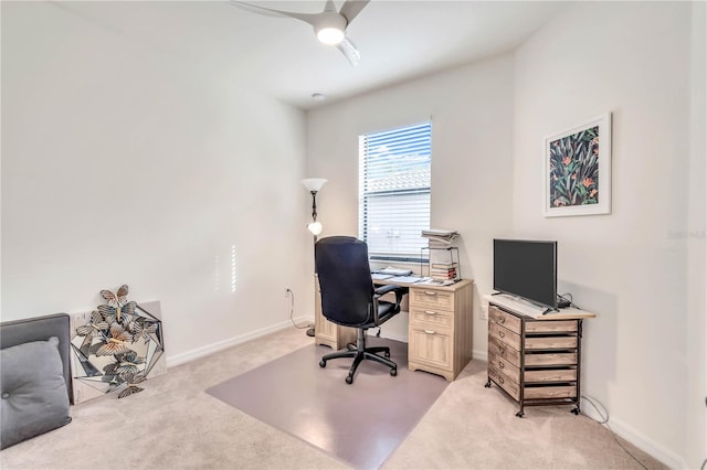 home office with light carpet and ceiling fan