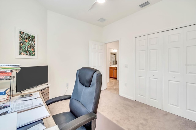 home office featuring light colored carpet and ceiling fan