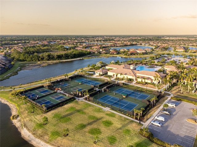 aerial view at dusk featuring a water view