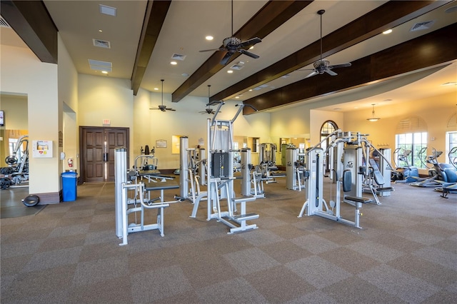 exercise room with ceiling fan and light colored carpet