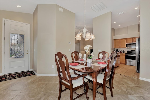 dining room with a notable chandelier and light tile flooring