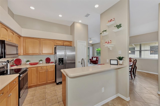 kitchen featuring appliances with stainless steel finishes, a wealth of natural light, ceiling fan, and light tile flooring