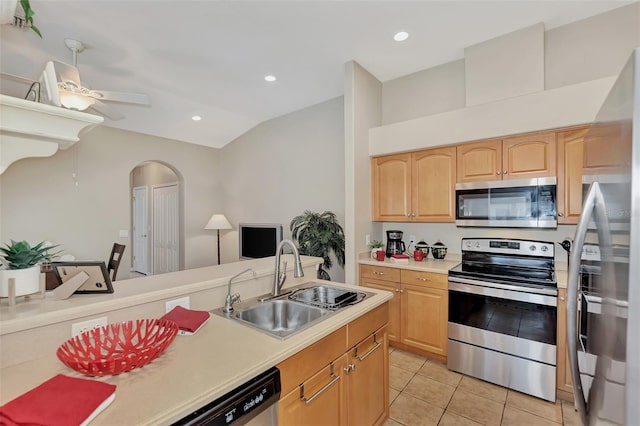 kitchen featuring ceiling fan, appliances with stainless steel finishes, light brown cabinets, sink, and light tile floors