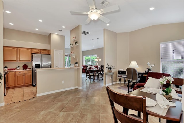 kitchen with ceiling fan with notable chandelier, light tile floors, range, decorative light fixtures, and stainless steel refrigerator with ice dispenser