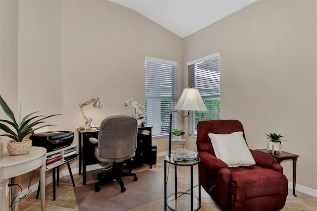 office space featuring lofted ceiling and light tile flooring