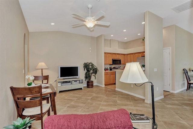 living room with vaulted ceiling, light tile flooring, and ceiling fan