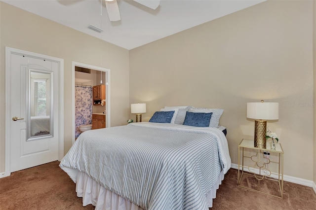 carpeted bedroom with ensuite bath and ceiling fan