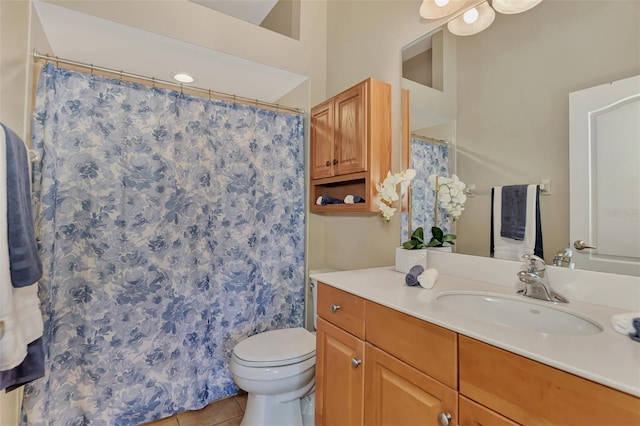 bathroom with toilet, vanity, and tile flooring