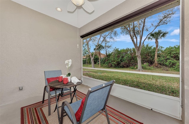 sunroom / solarium with plenty of natural light and ceiling fan