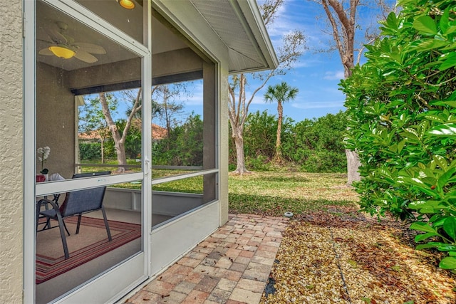 exterior space with ceiling fan