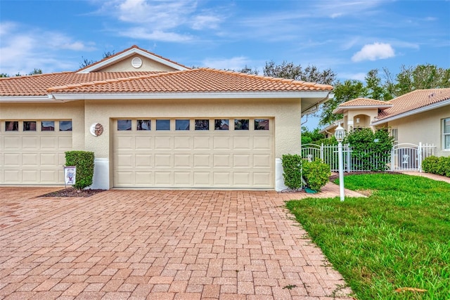 mediterranean / spanish-style house with a front yard and a garage