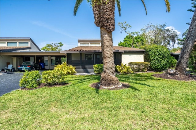 view of front of house with a front yard and a carport