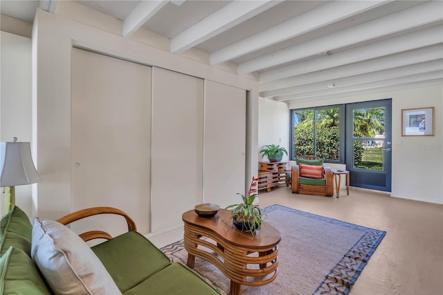 living room featuring french doors and beam ceiling