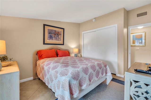 bedroom featuring light tile flooring and a closet