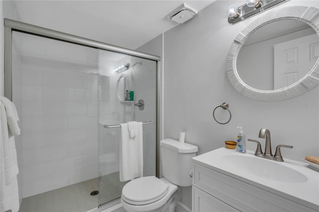 bathroom with vanity, toilet, and walk in shower