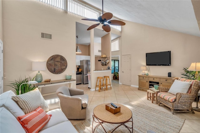 living room featuring high vaulted ceiling, a healthy amount of sunlight, ceiling fan, and light tile floors