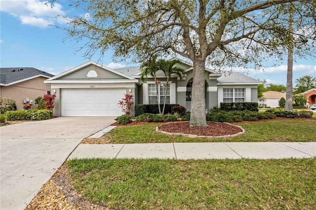 single story home featuring a front lawn and a garage