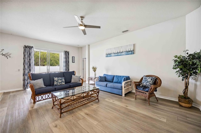 living room featuring light hardwood / wood-style floors and ceiling fan