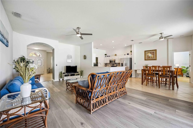 living room with light hardwood / wood-style floors and ceiling fan