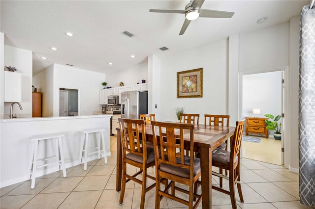 dining space featuring ceiling fan and light tile flooring