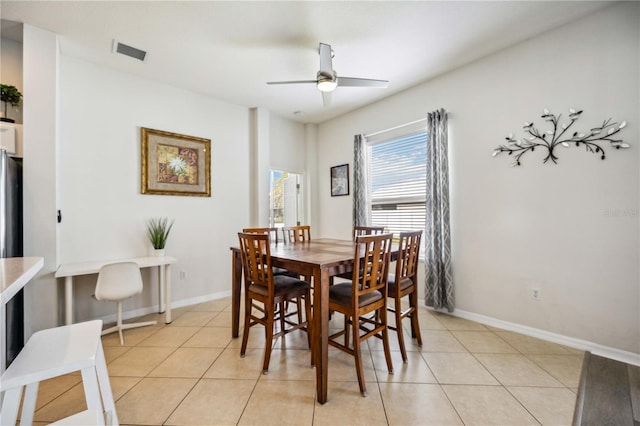 tiled dining space featuring ceiling fan