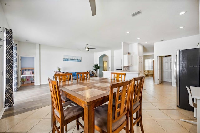 tiled dining space with ceiling fan