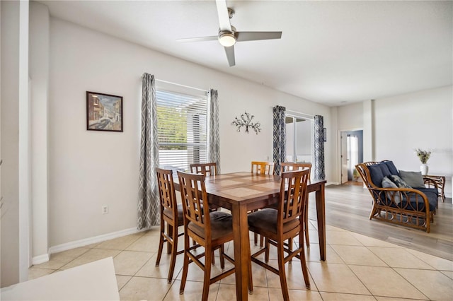 dining room featuring light tile flooring and ceiling fan