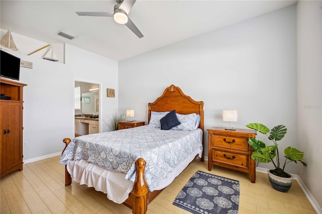 bedroom featuring connected bathroom, ceiling fan, and light wood-type flooring