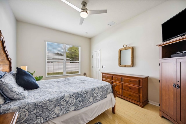 bedroom with ceiling fan and light hardwood / wood-style flooring