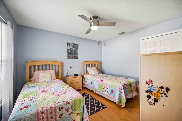 bedroom with hardwood / wood-style floors and ceiling fan