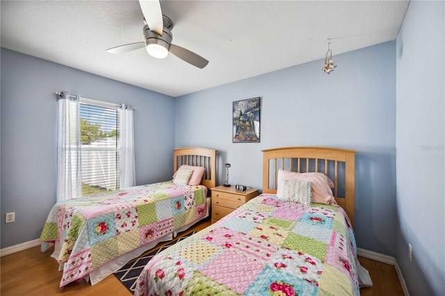 bedroom with ceiling fan and hardwood / wood-style flooring