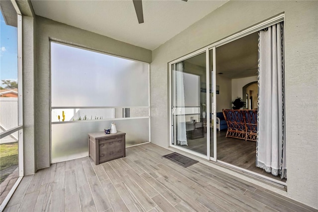 sunroom featuring ceiling fan