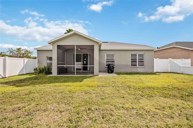 back of property with central AC unit, ceiling fan, a lawn, and a patio area