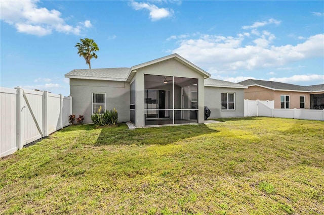 back of property featuring a yard and a sunroom