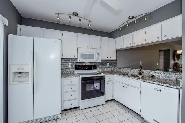 kitchen with tasteful backsplash, white appliances, sink, and white cabinets