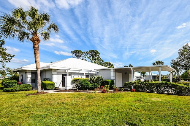 ranch-style home featuring a carport and a front yard